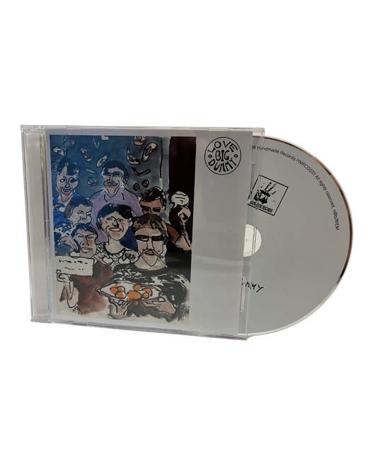 The selftitled debutalbum from Love Big Dummy on CD in a clear plastic jewel case with the album art visible on the front and a silver CD partially slid out, shown on a plain white background.